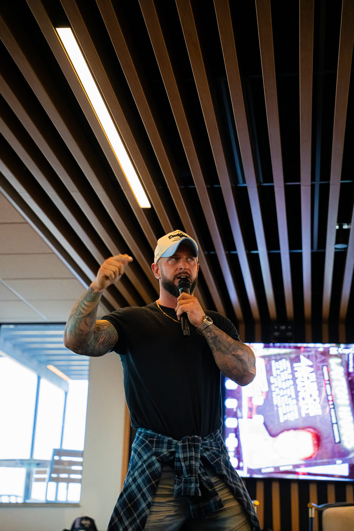 A speaker addressing attendees with a microphone during a Man Days Project life-skills session