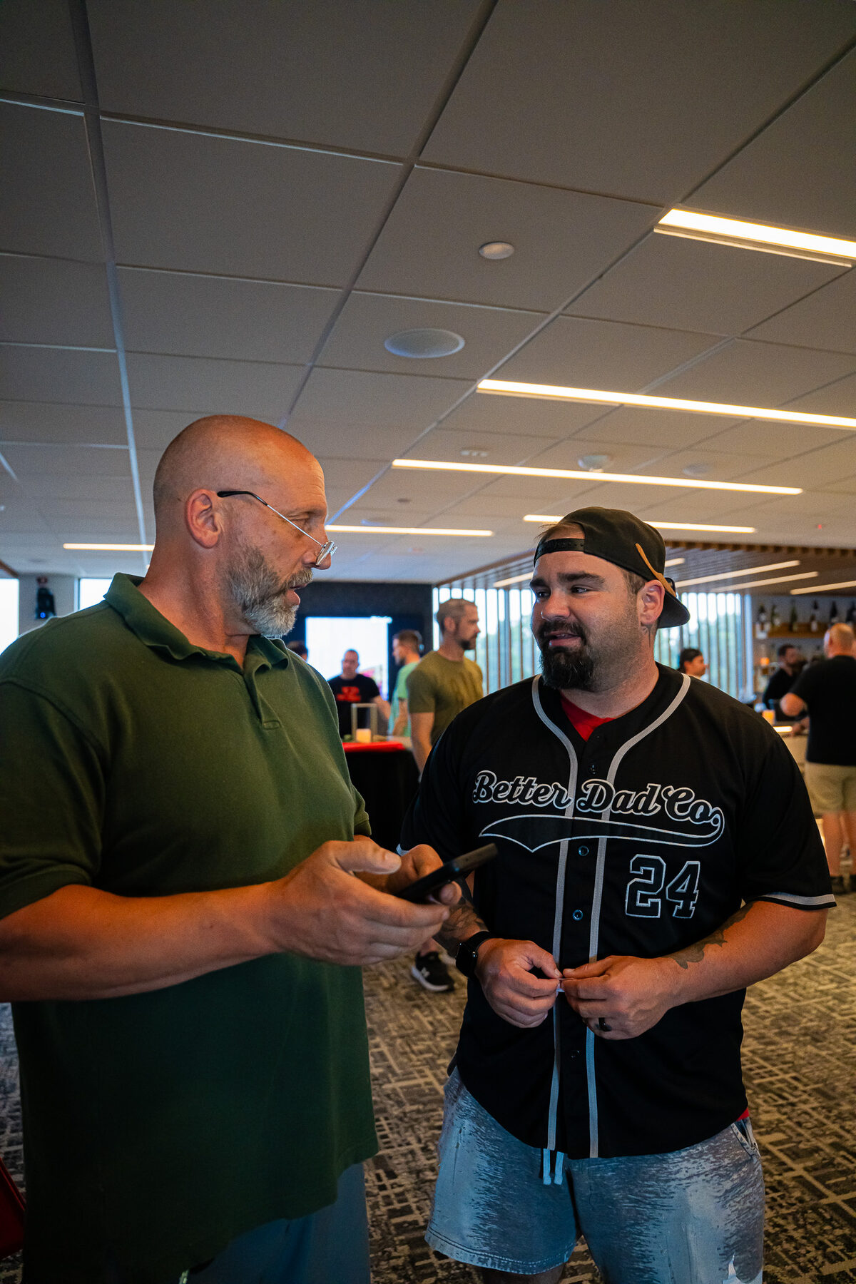 An experienced man mentoring a younger man in a one-on-one conversation at a Man Days Project event